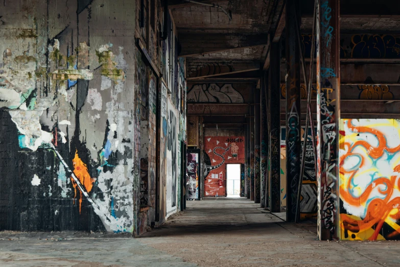 an industrial area with graffiti on the walls