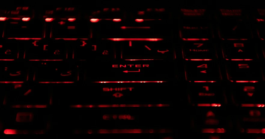 an illuminated image of a keyboard in a dark place