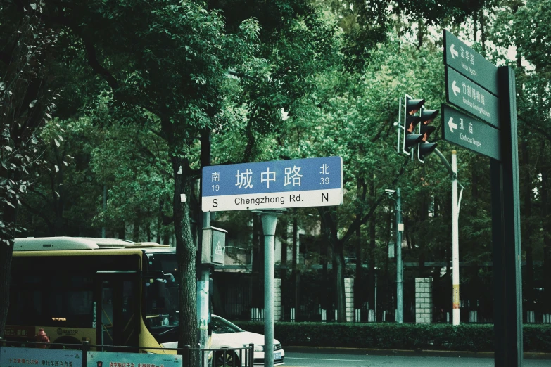 a bus stopped at the stoplight on a quiet street