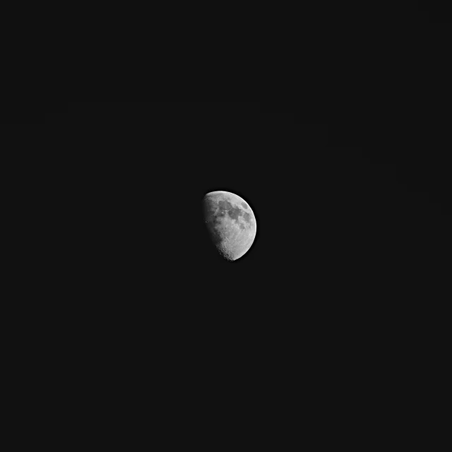 the moon is seen through a dark sky