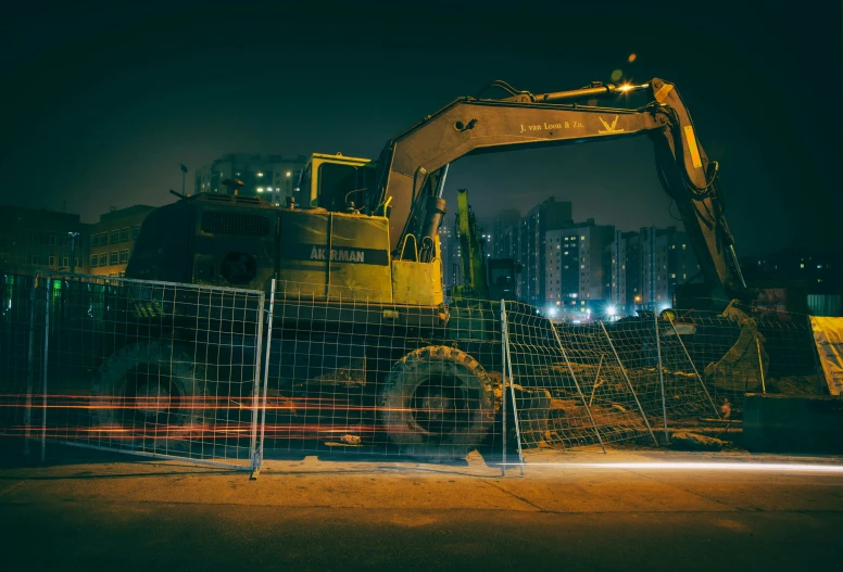 the bulldozer is parked by the building site