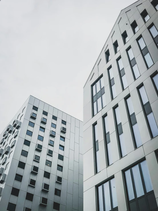 a grey building with many windows is shown against the sky