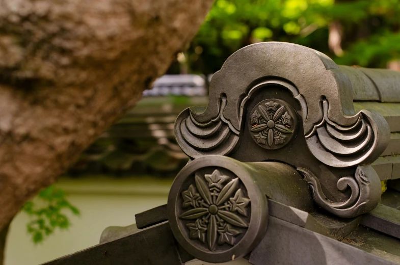 a metal bird ornament sits on top of a roof