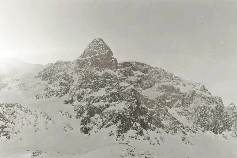 a skiier is in front of a snowy mountain