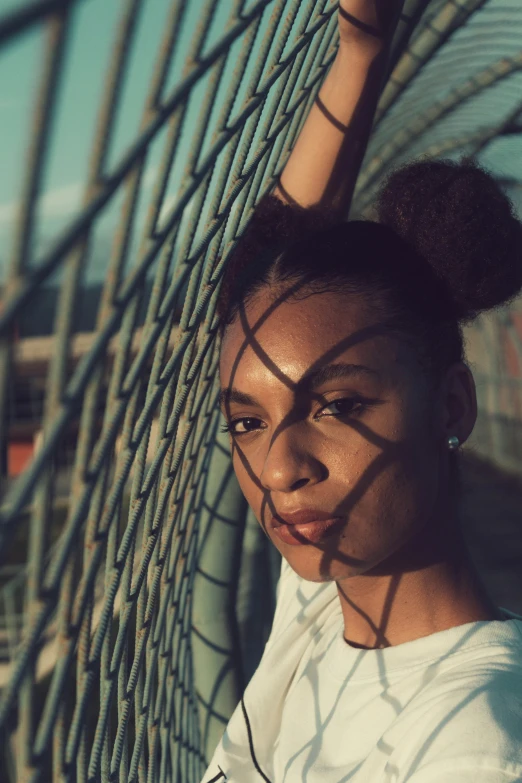 a woman is looking through the fence