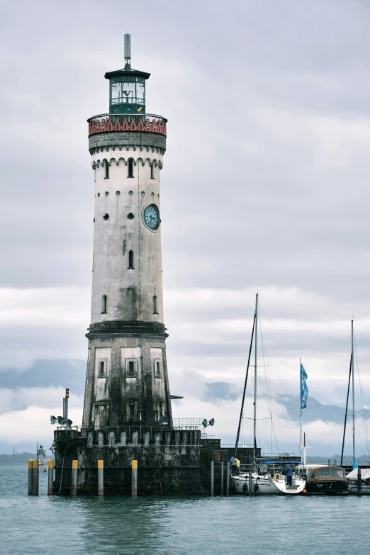 the clock tower stands at the end of the pier