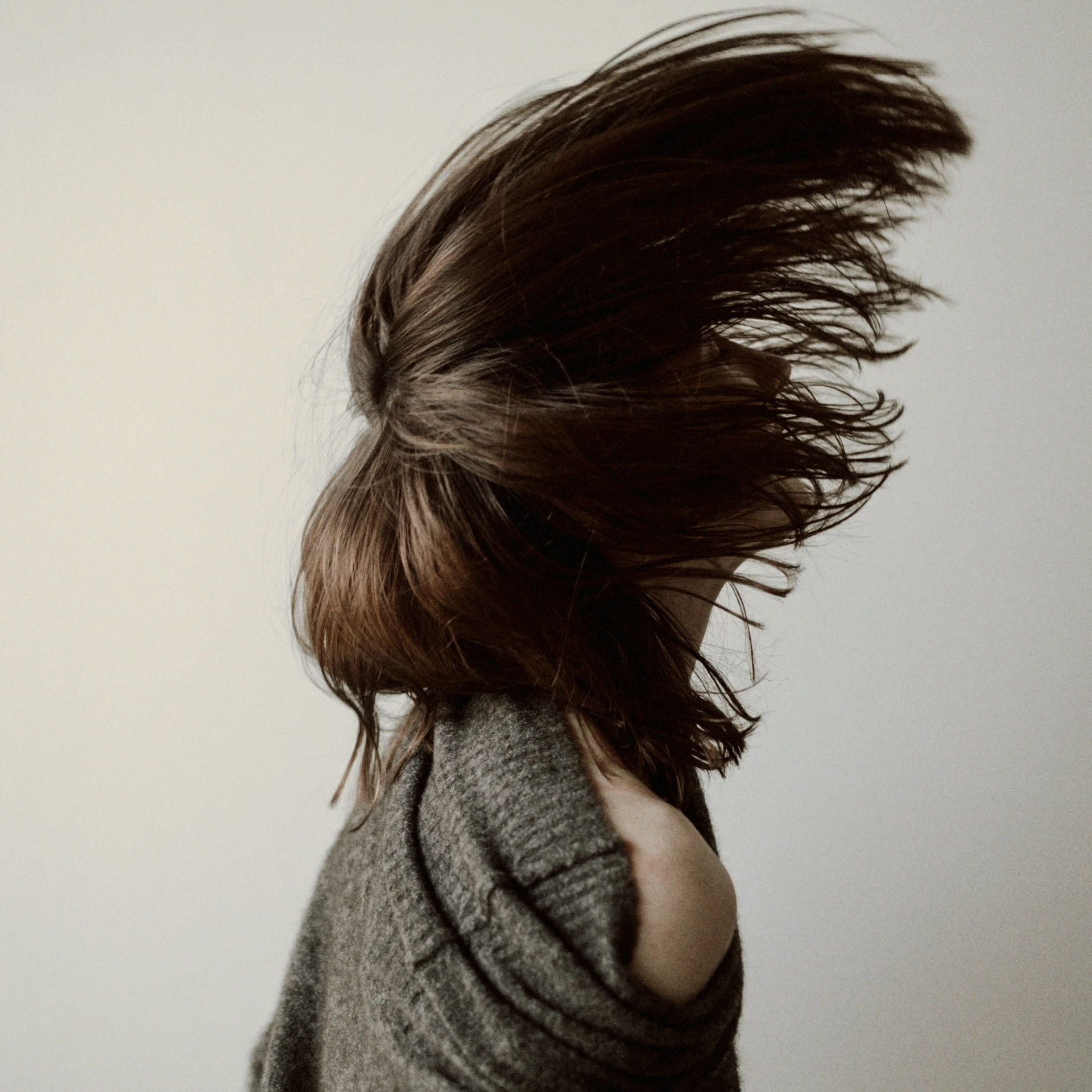 a woman with her hair flying in the air