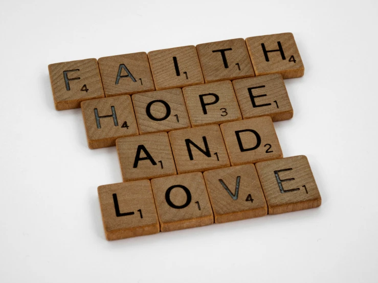 three scrabble letters spelling faith, hope and love