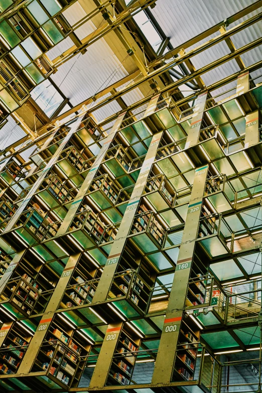 a large glass and metal building in the shape of bookshelves