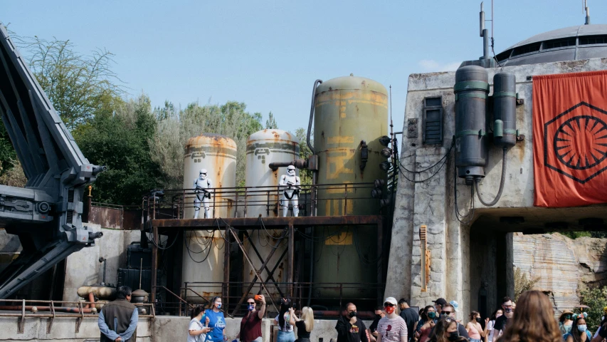 a group of people stand in front of several giant structures