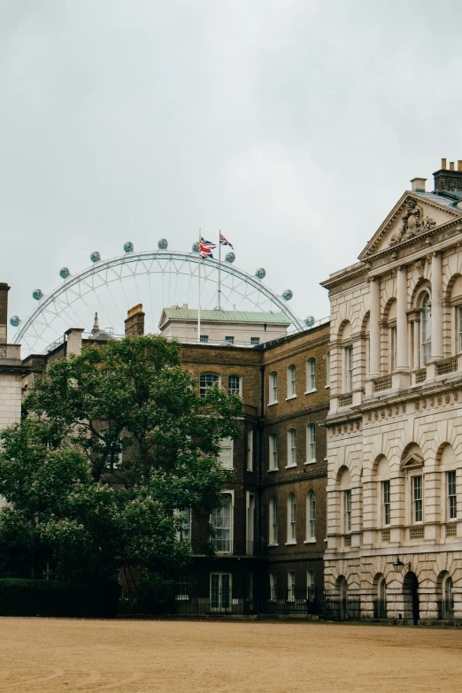 some buildings and an ferris wheel outside of them