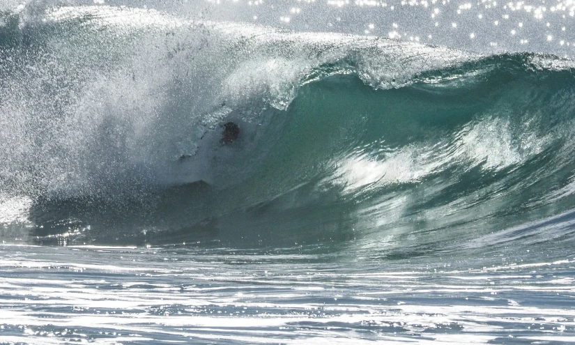 a man riding a big wave in the ocean