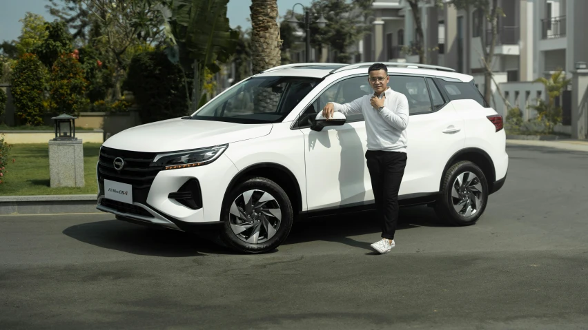 a man stands next to his new car