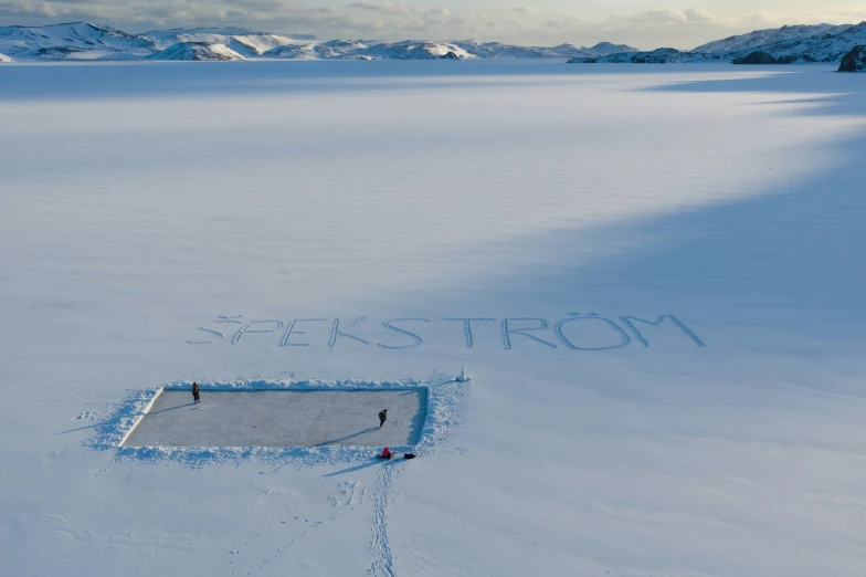 a picture with writing on the ground in the snow