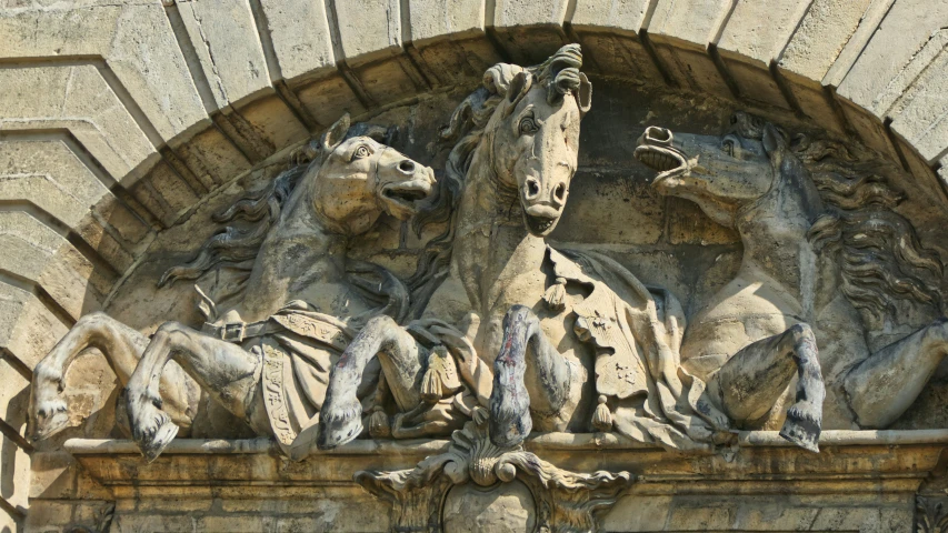 statues sitting on the outside of a building