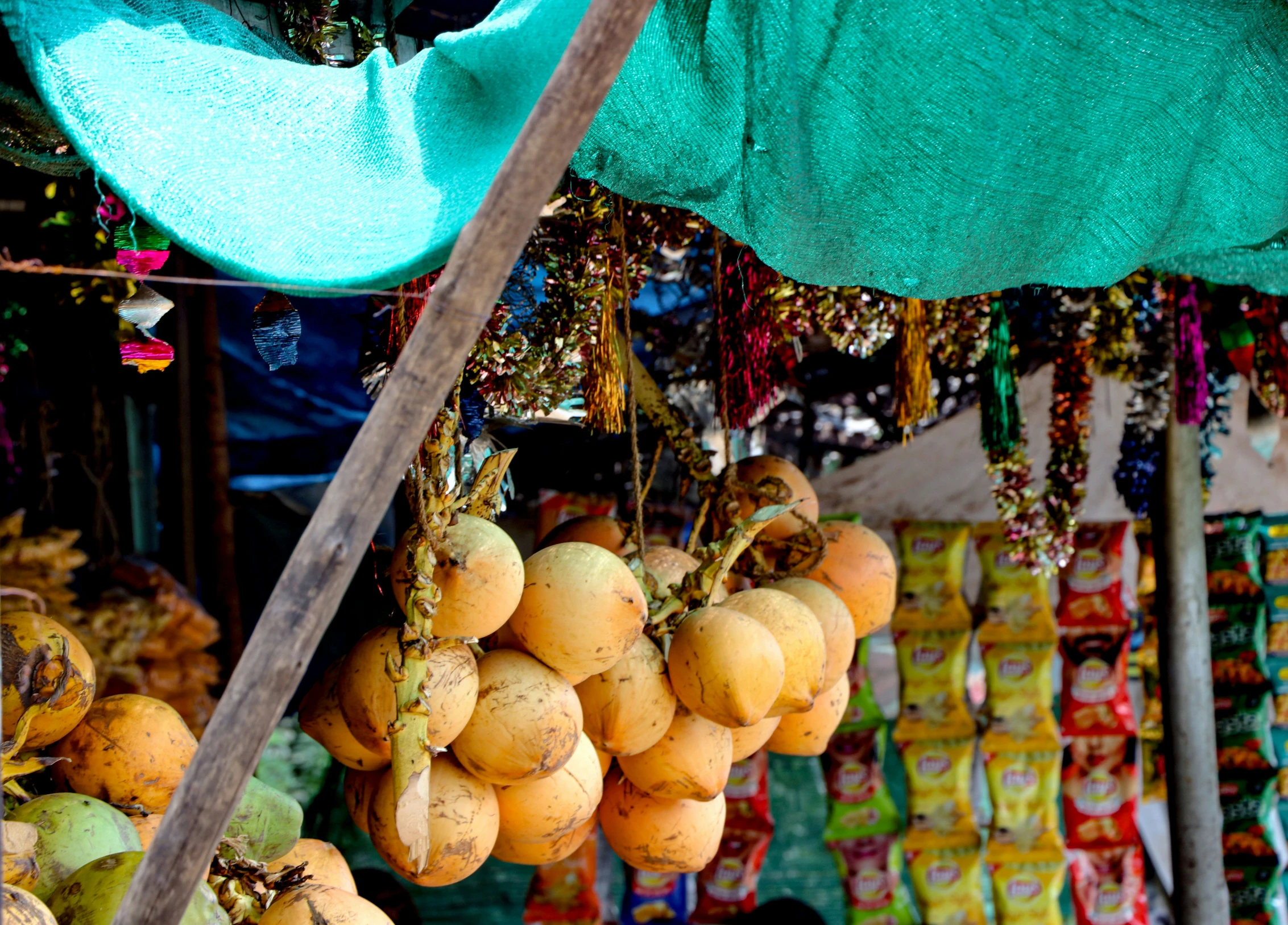 a bunch of fruit hanging from a pole