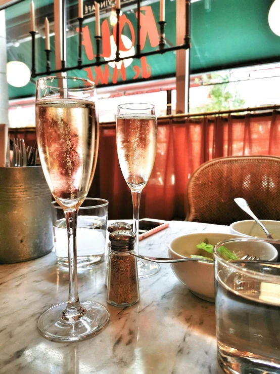 two glasses filled with liquid on top of a table