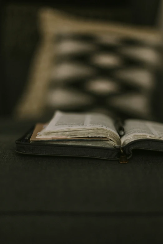 a close up of an open book on a couch