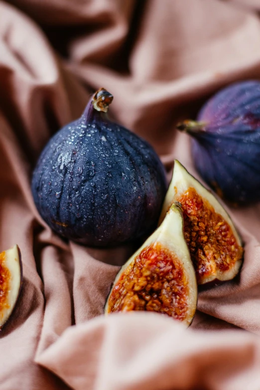 there are figs, and the whole one is on a cloth