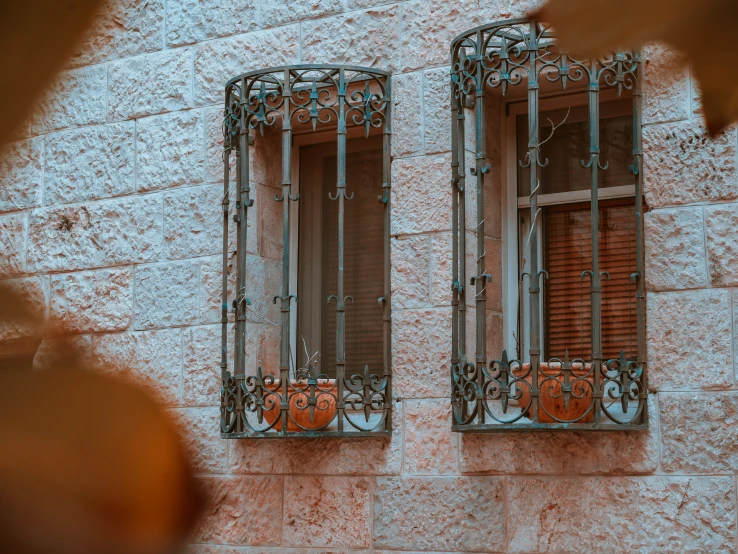 window frames with iron work outside a brick building