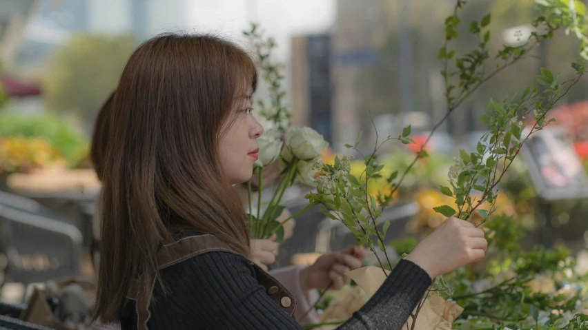 a young woman is tending to flowers in her garden