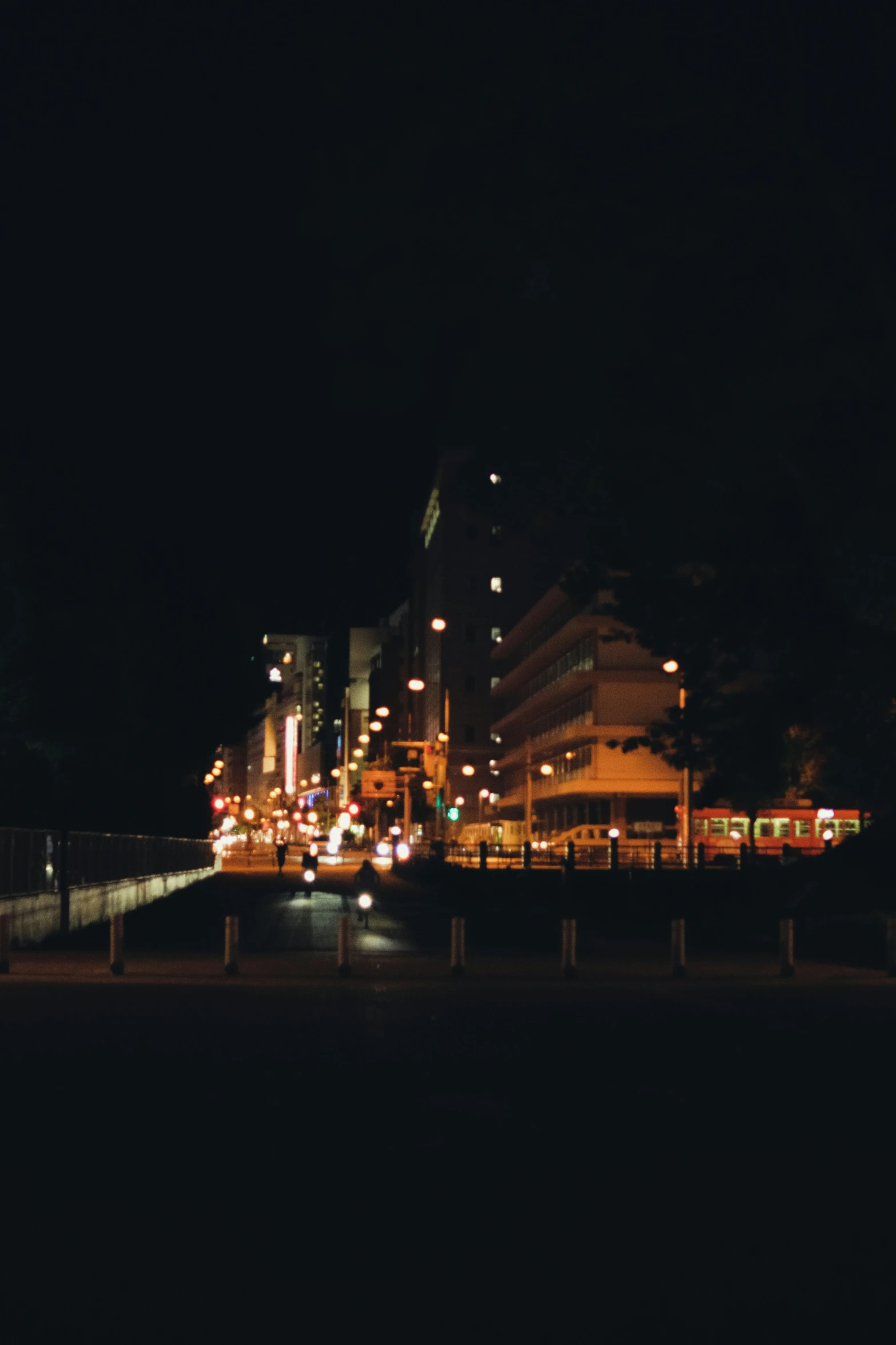 many street lights in front of buildings on a dark day