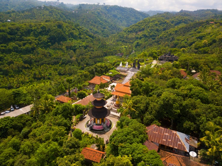 an aerial view of an oriental style resort surrounded by trees