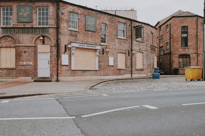 a very big nice old brick building by the street