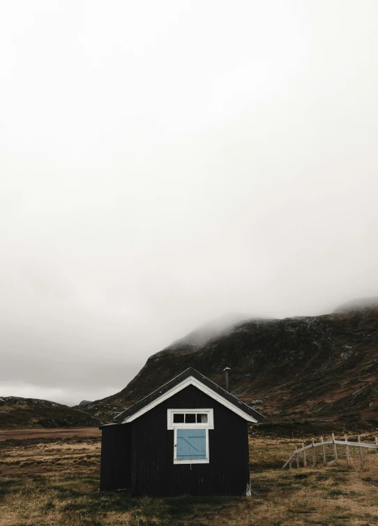 there is a black shack on the hill