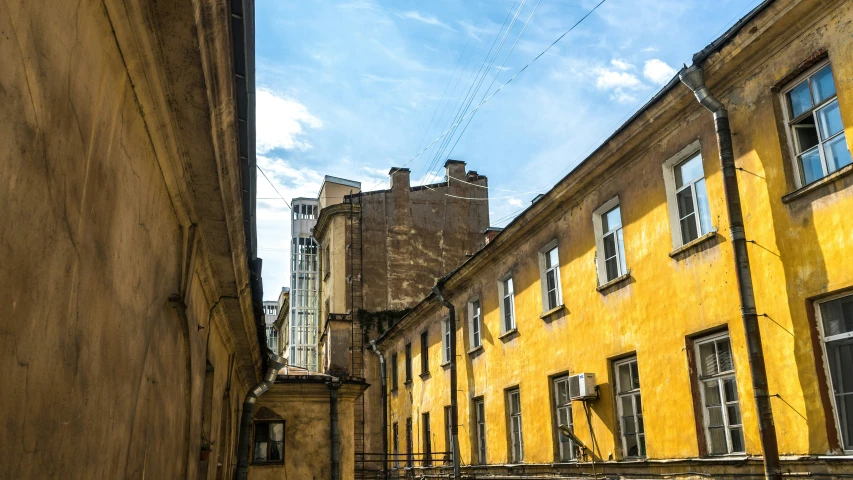 a row of old buildings with cars parked by them