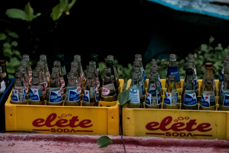 many empty soda bottles in yellow containers