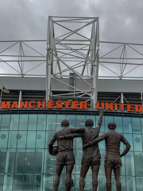statue of three men with the name manchester united