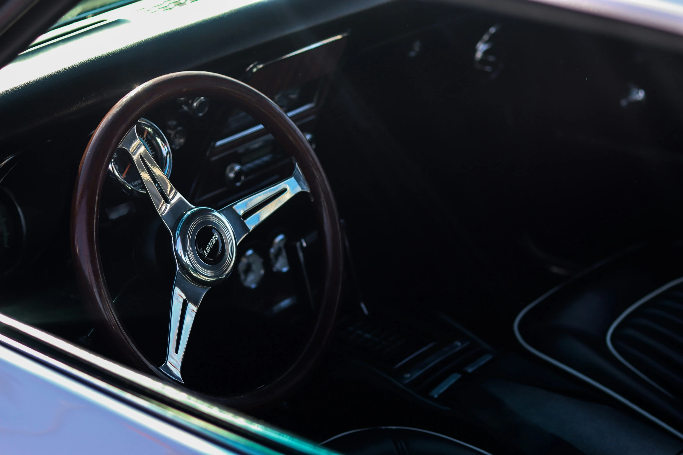 the steering wheel and dash light of an older style car