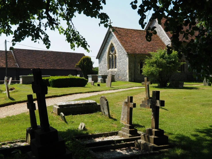 a church with several headstones placed outside of it