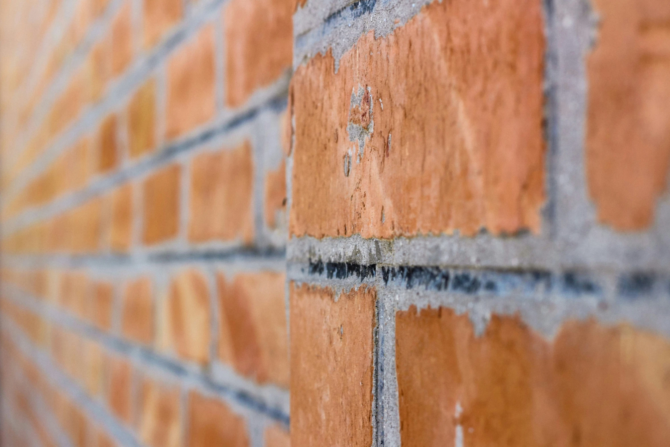 a red brick wall has an arrow painted on it