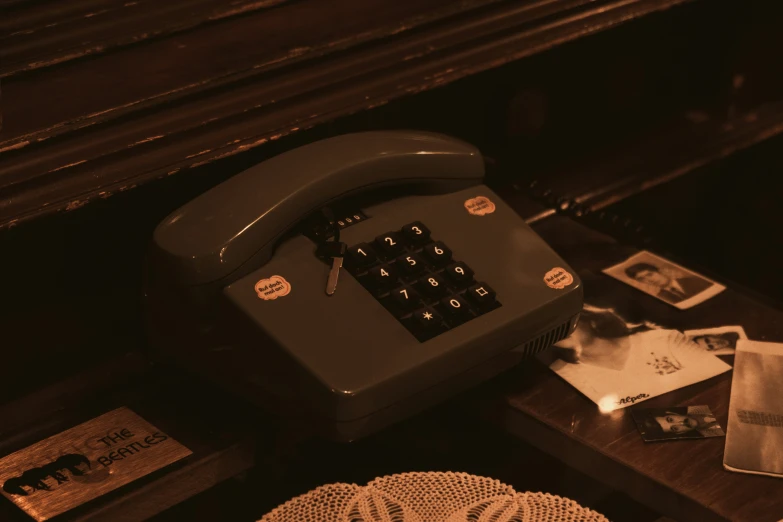 a desk with an old fashioned type of phone on it