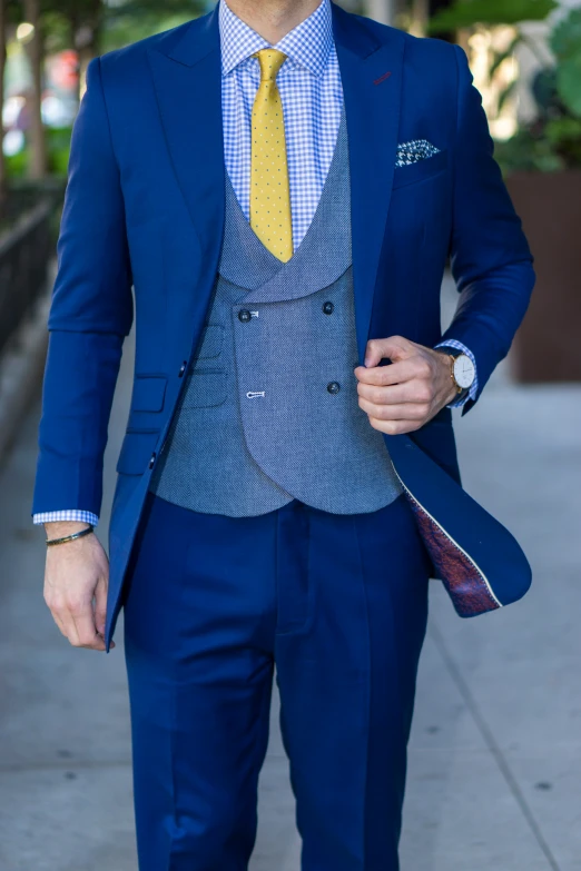 a man dressed in a suit with yellow tie and sunglasses