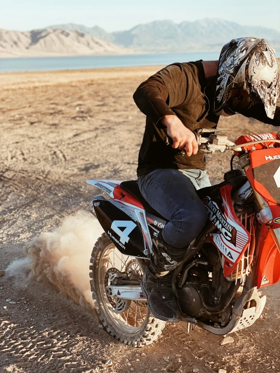 a man wearing a hat and sitting on a dirt bike