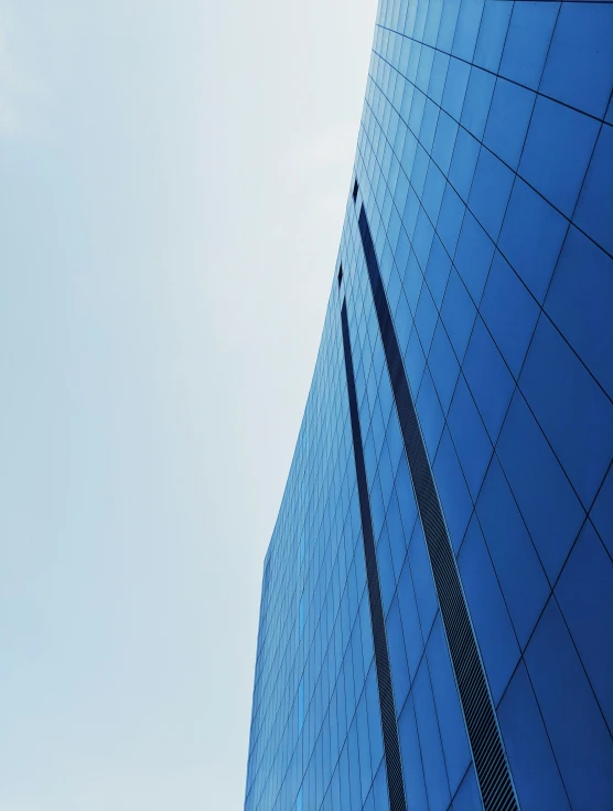 a blue building with a clock in front of it