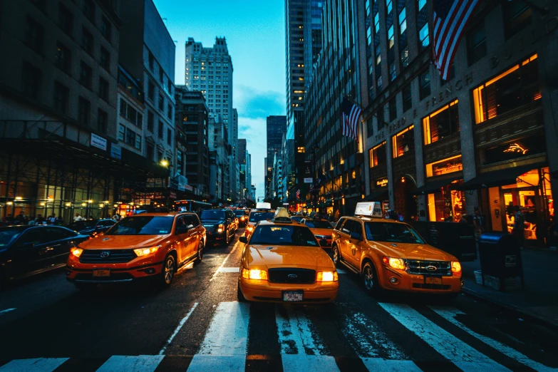 an image of city traffic on the street at dusk