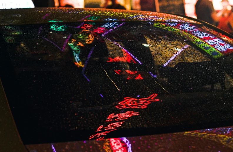 a car covered with colorful lights in a crowd