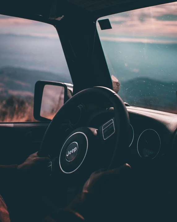 a car driving next to a beautiful view