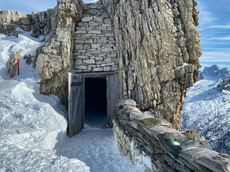 a large stone structure on top of a snow covered mountain