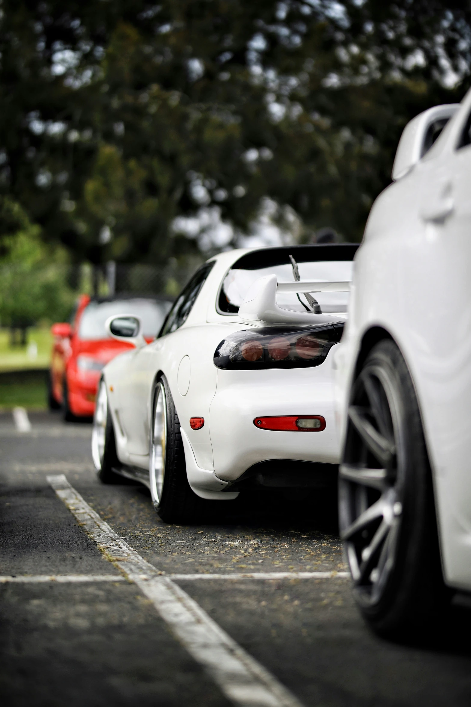 several white sports cars parked in a parking lot