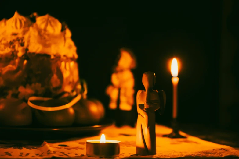 the lit candles are beside of the doll