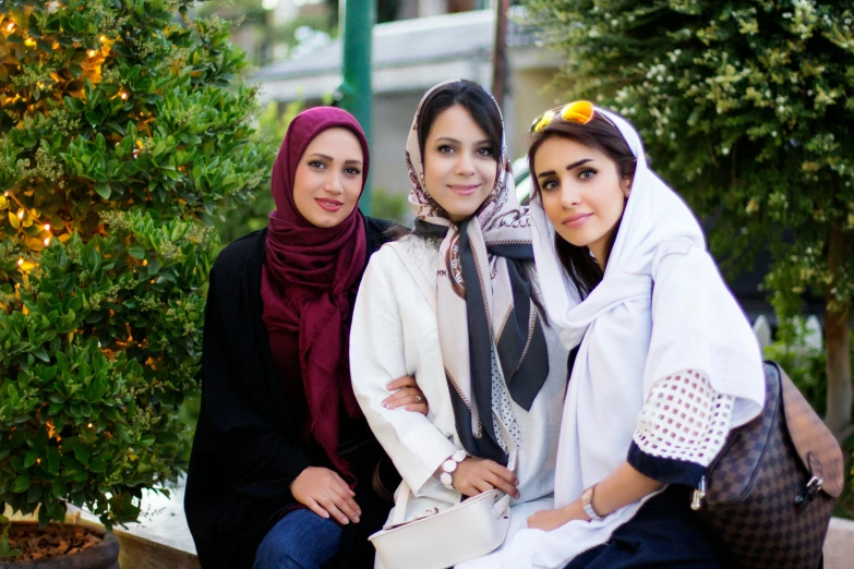 two women sitting down with one woman hugging another women