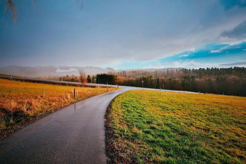 this is an image of a road that runs through a field