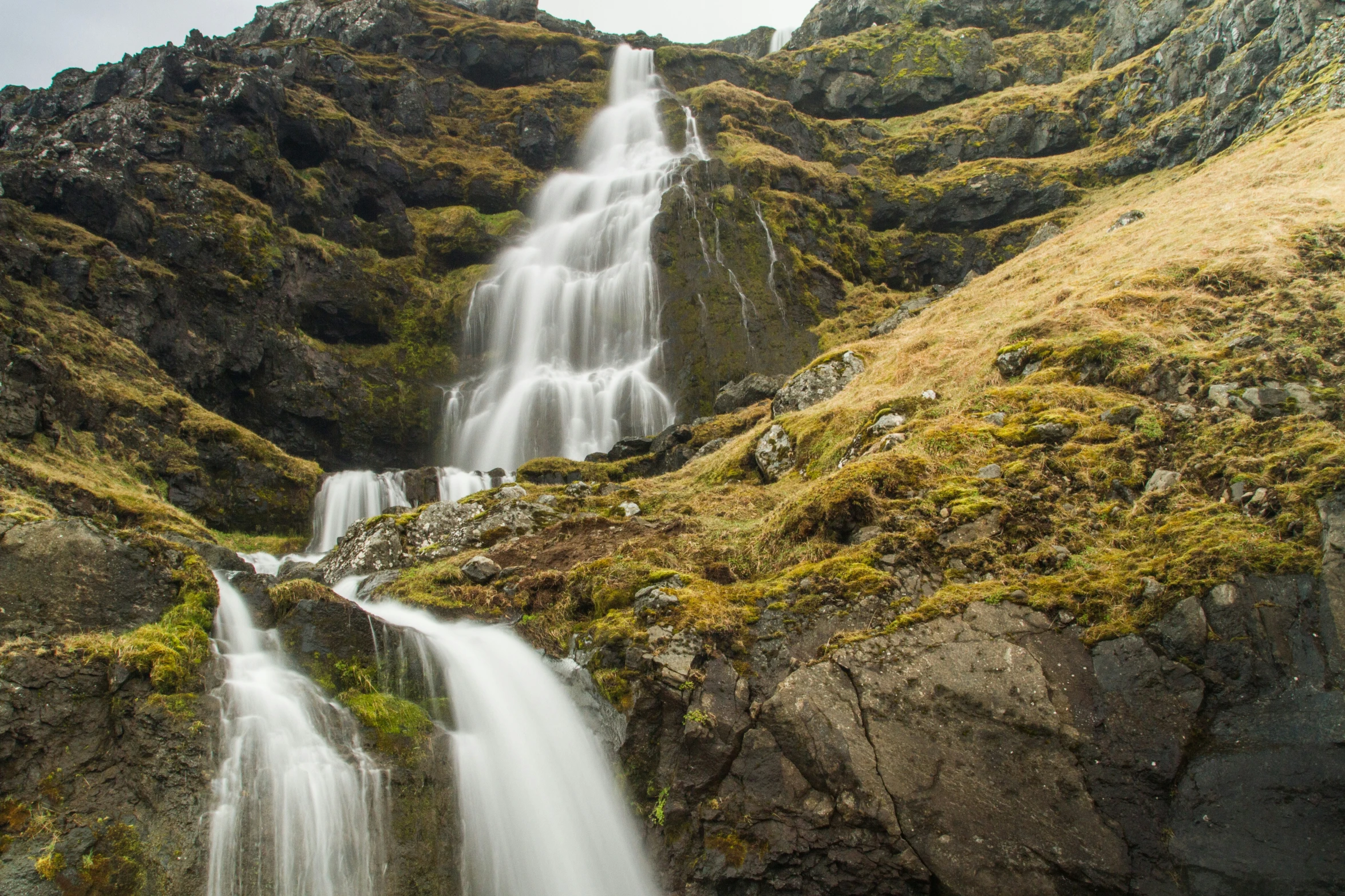 a large waterfall falls into the water