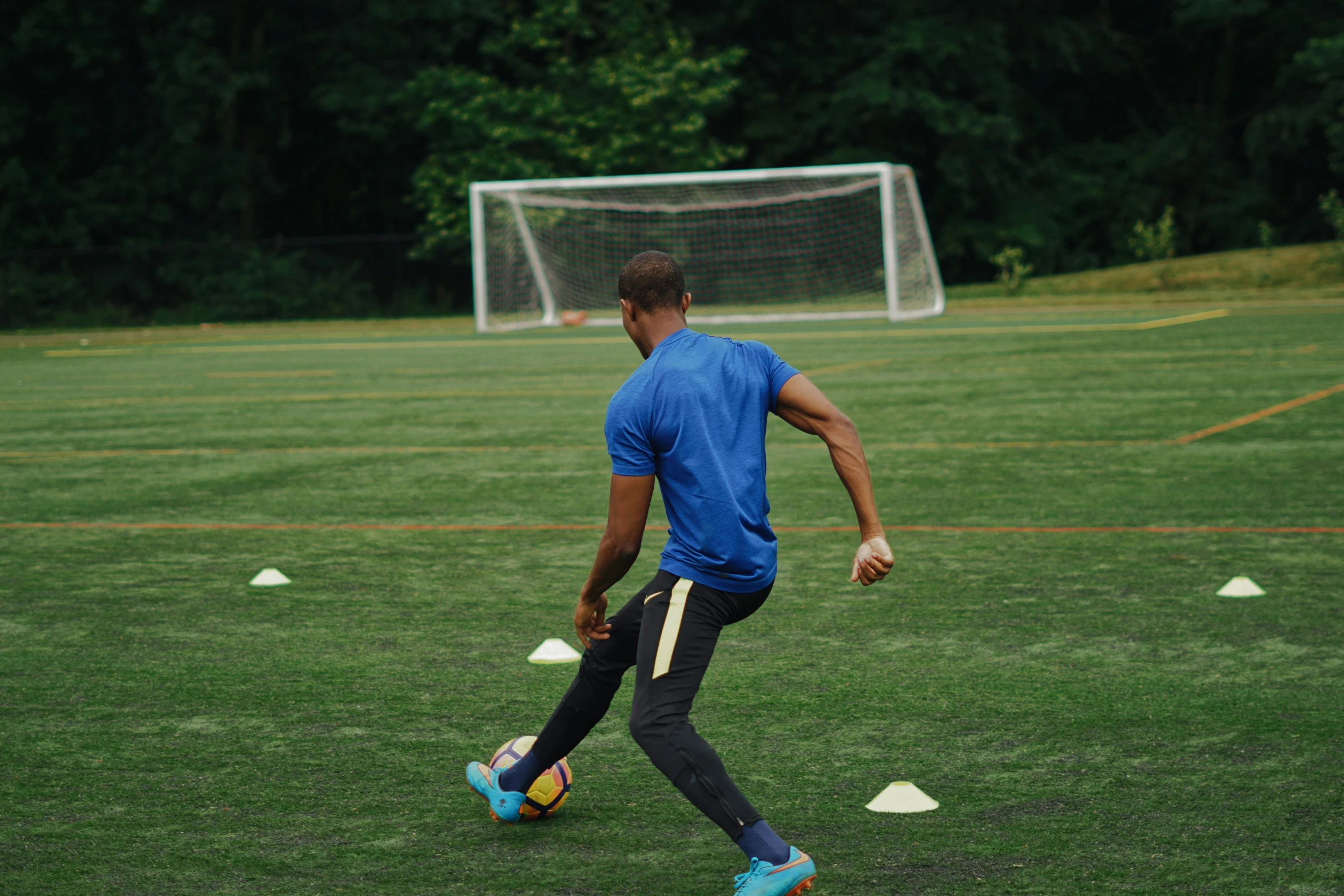 a man standing on top of a lush green soccer field