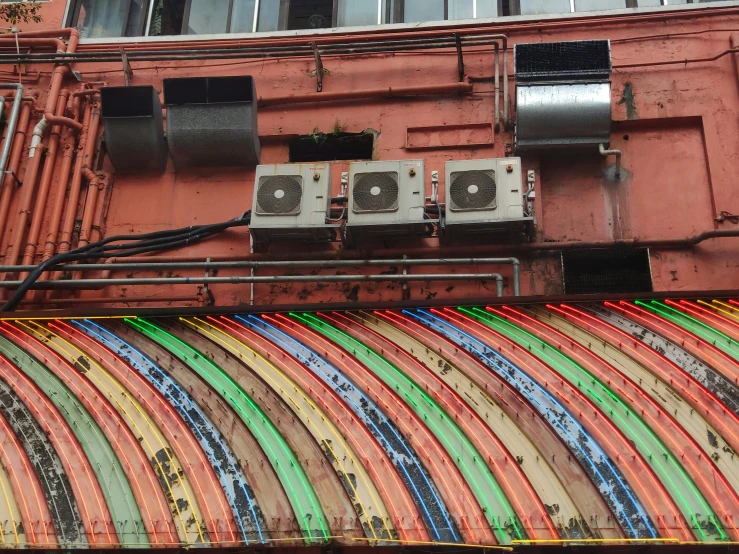 the large array of colorful wall panels are hanging in front of an apartment